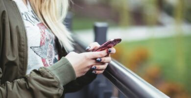 woman holding red phone Lada 722